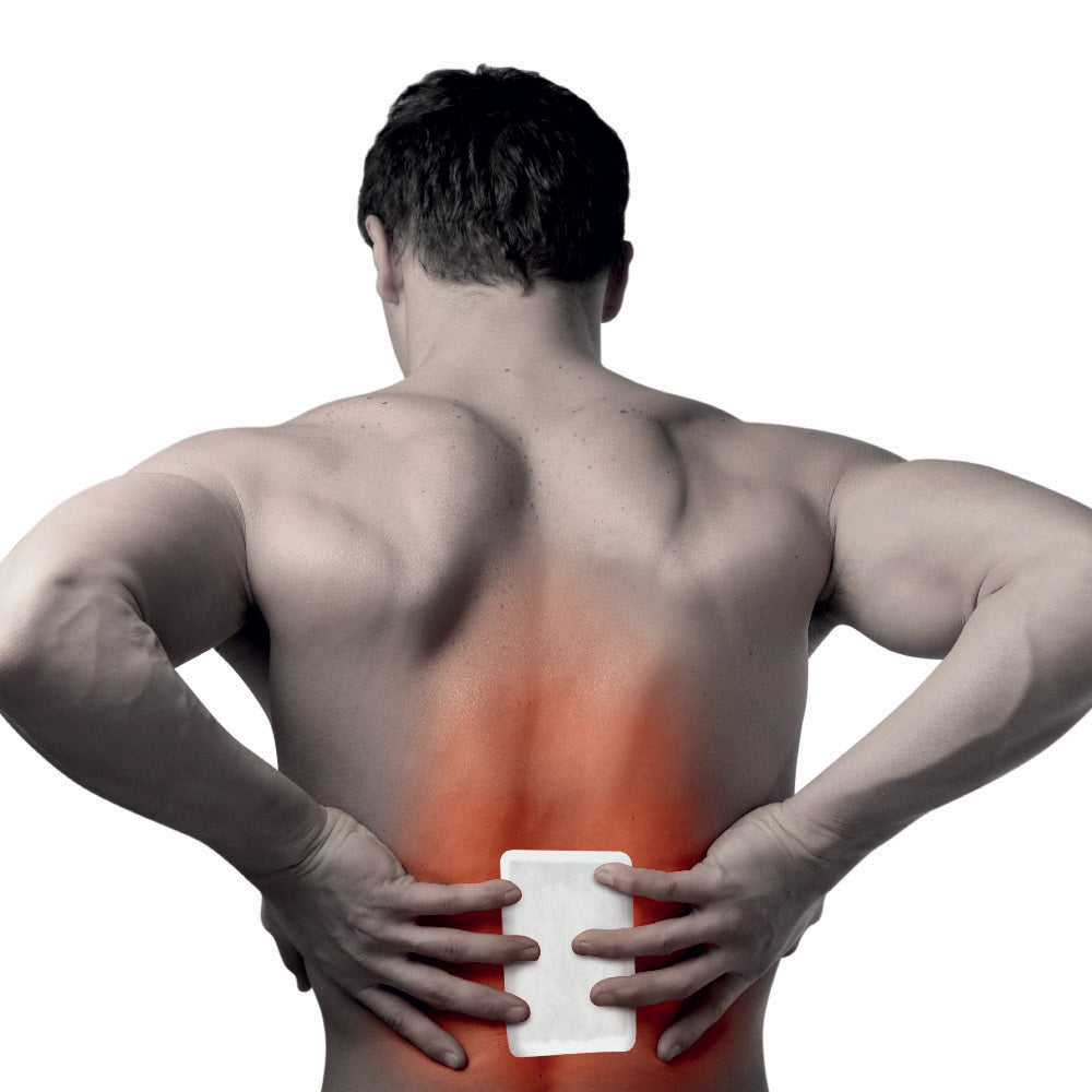 Man holding a white heating pad to his back with a red highlight indicating pain or pressure point.