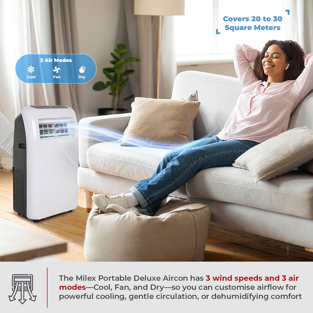 Woman relaxing on a couch next to a Milex portable air conditioner in a living room.