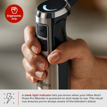 Hand holding a Milex Nutri Press Pro Blender with ergonomic grip and light indicator.